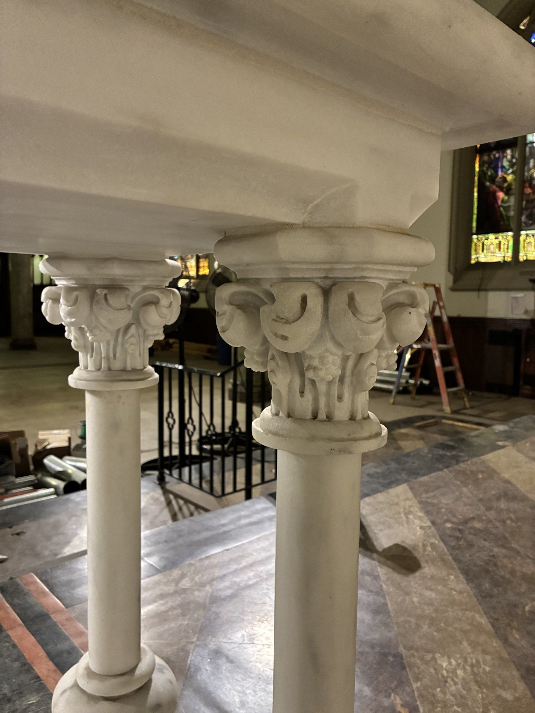 Close-up of one of the marble colonnettes supporting the communion table, with its carved foliate capital, inside the church.