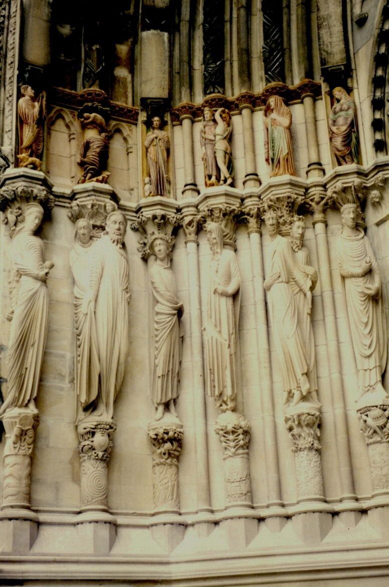 The completed left side of the Portal of Paradise — rows of carved limestone saints set into gothic niches at the Cathedral of St. John the Divine.